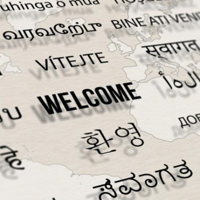 welcome-different-language-paper-with-world-map-background-words-cloud-concept